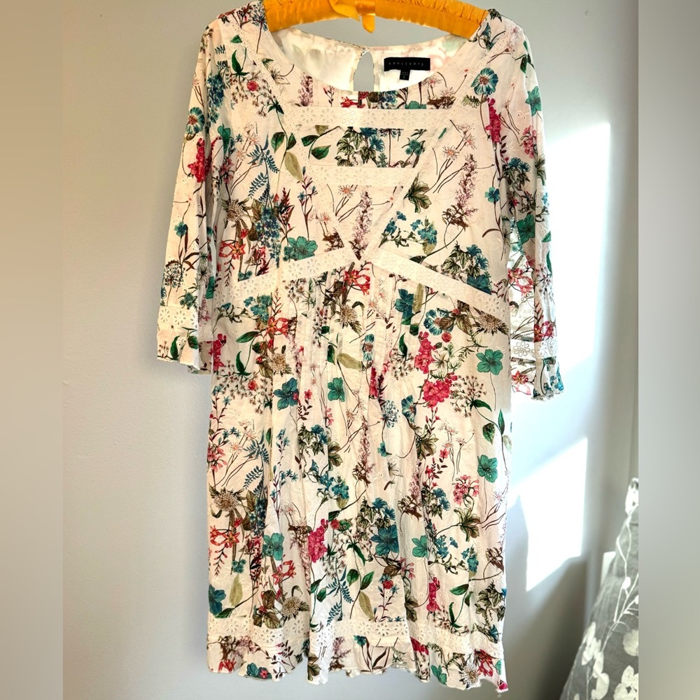 White dress with floral pattern. Sleeves, hits mid-thigh. Sanctuary brand size L